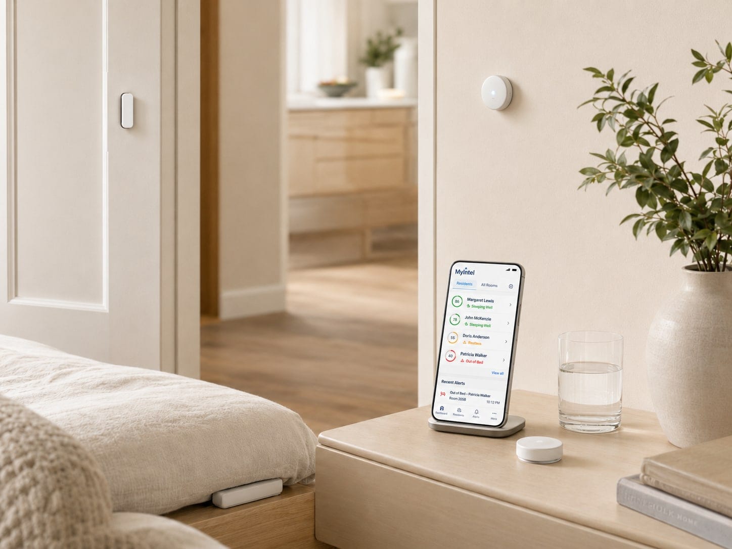 Phone on a nightstand showing a MyIntel list of residents and recent alerts, with a sensor on the wall